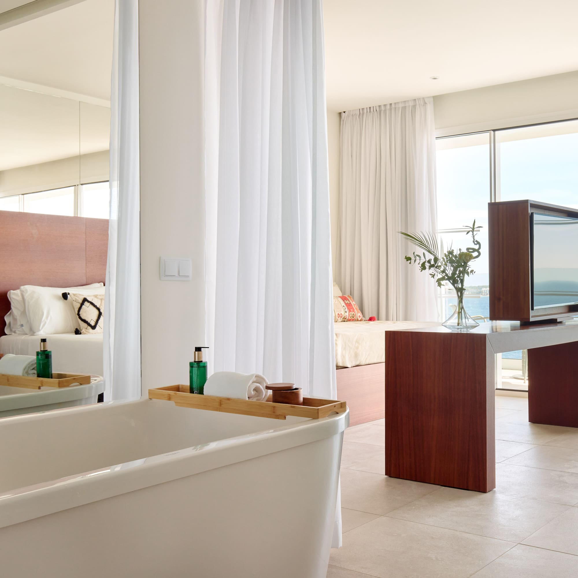 a bathroom with a large mirror and a tub