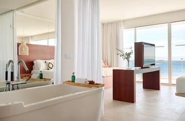 a bathroom with a large mirror and a tub