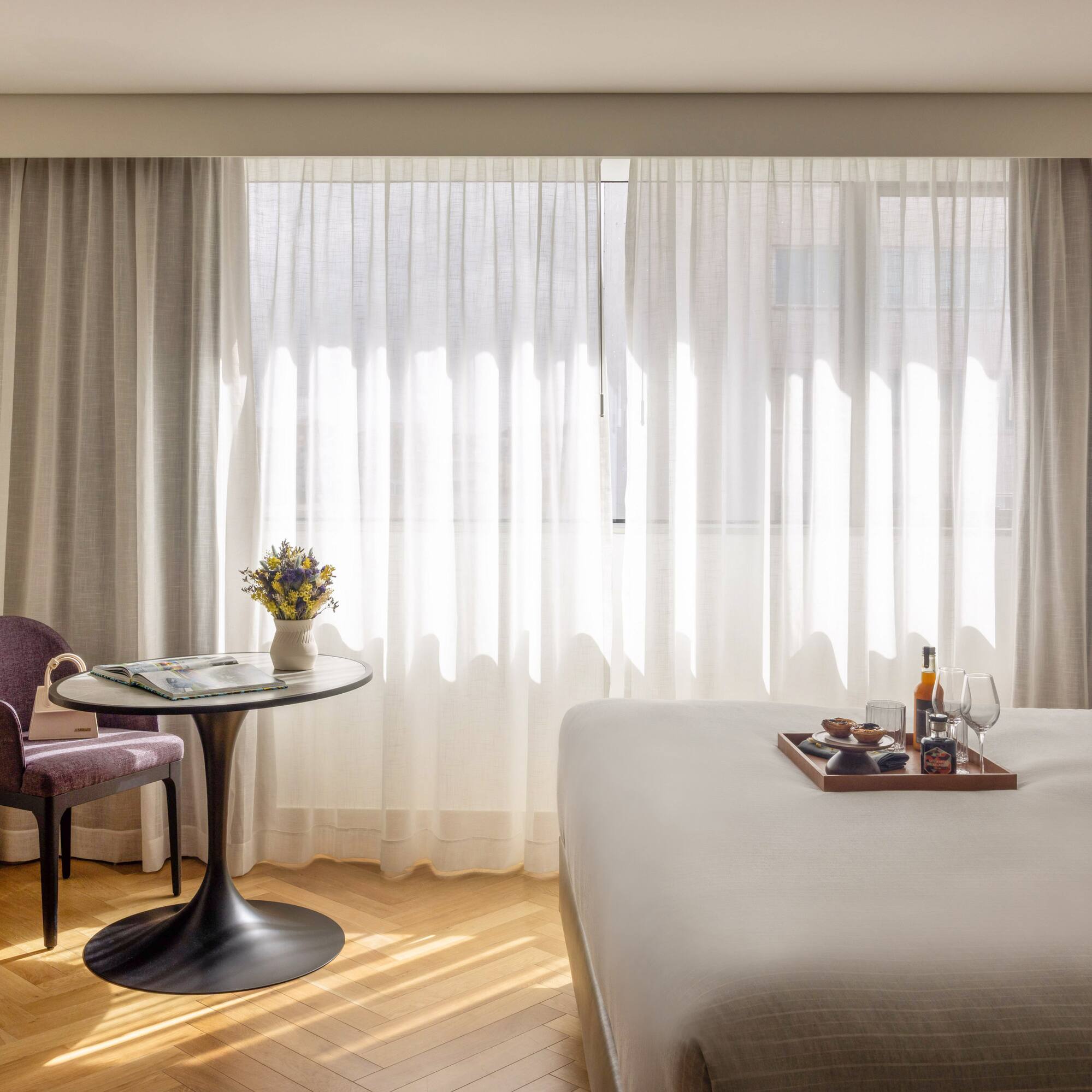 a room with a bed and a table and chairs