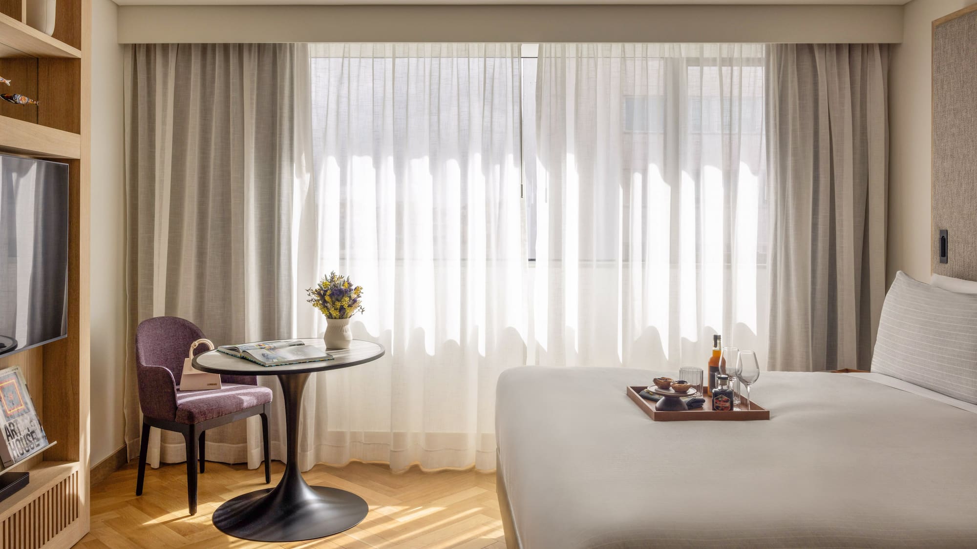 a room with a bed and a table and chairs