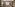 Habitación de hotel de lujo con cama king, sofá, mesa y armario empotrado.