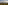 Hazy volcano with clouds overlooking a green village and rolling hills.