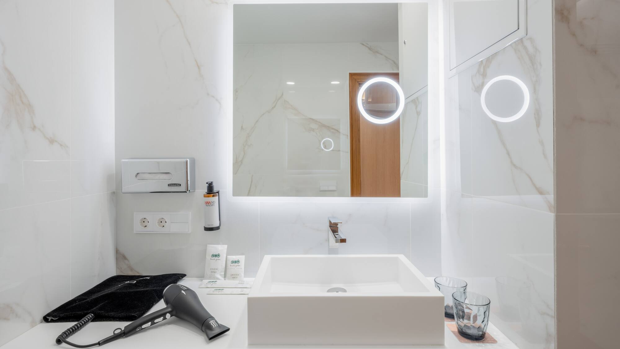 a bathroom with a mirror and a blow dryer