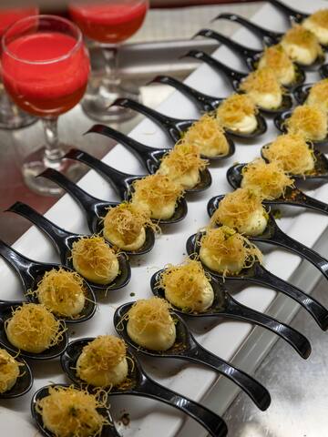 a row of spoons with food on them