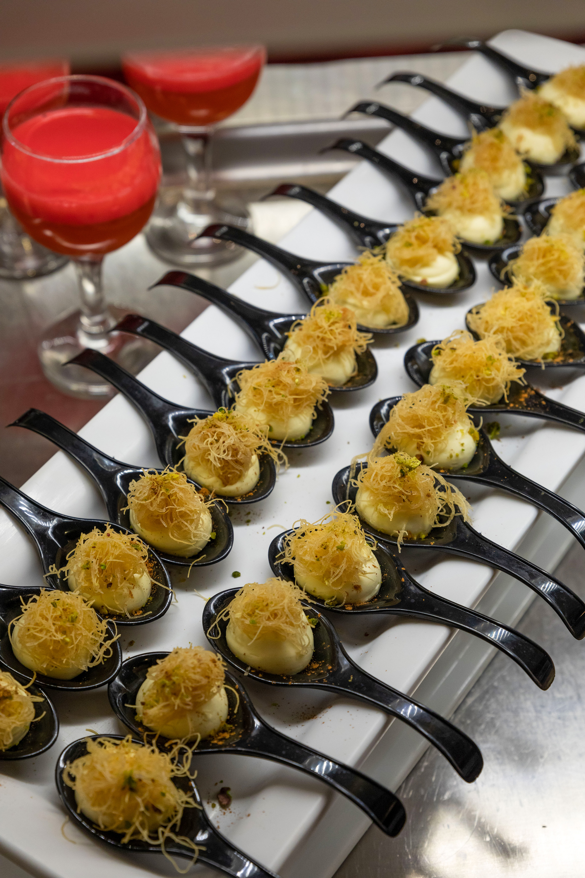 a row of spoons with food on them