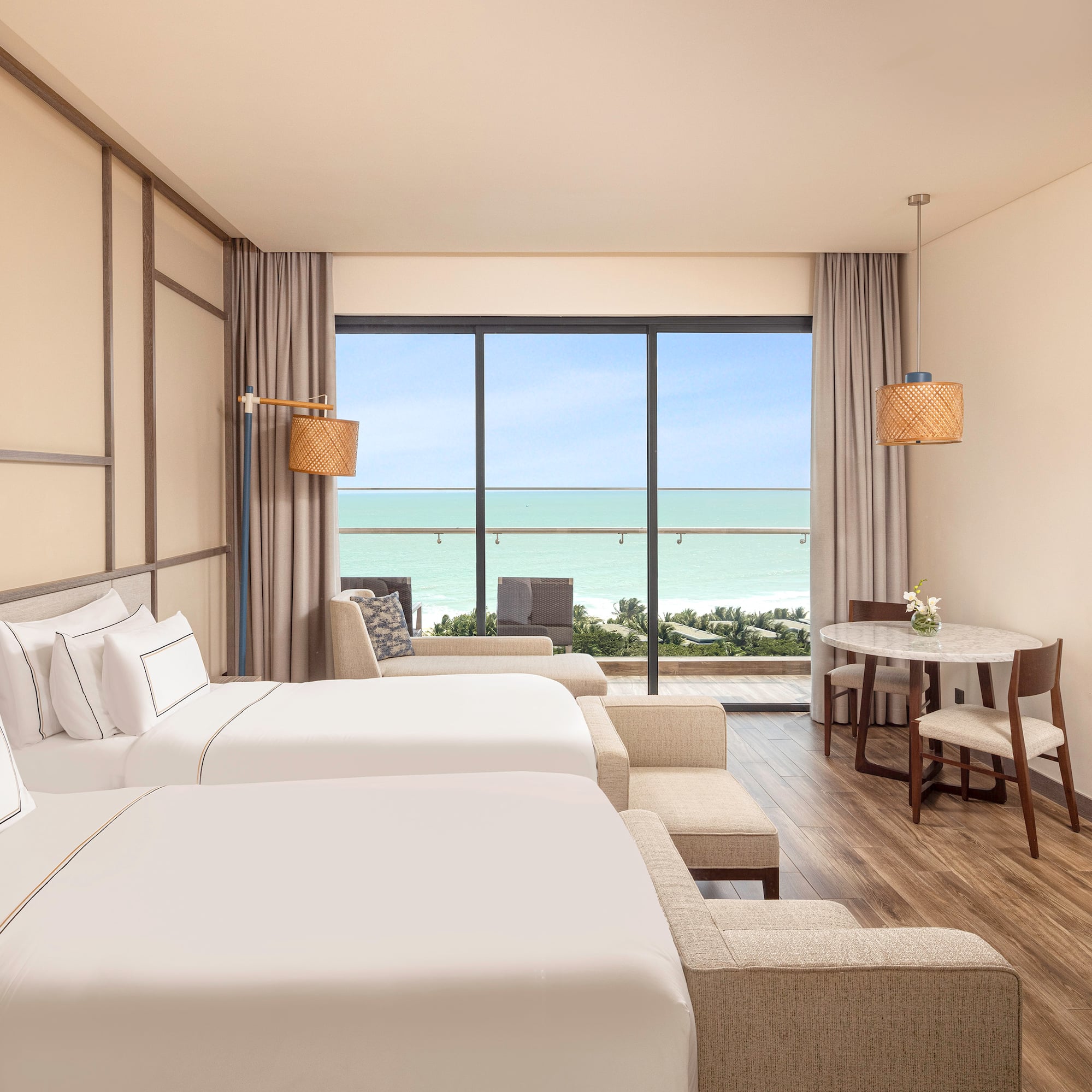 a room with two beds and a table and chairs