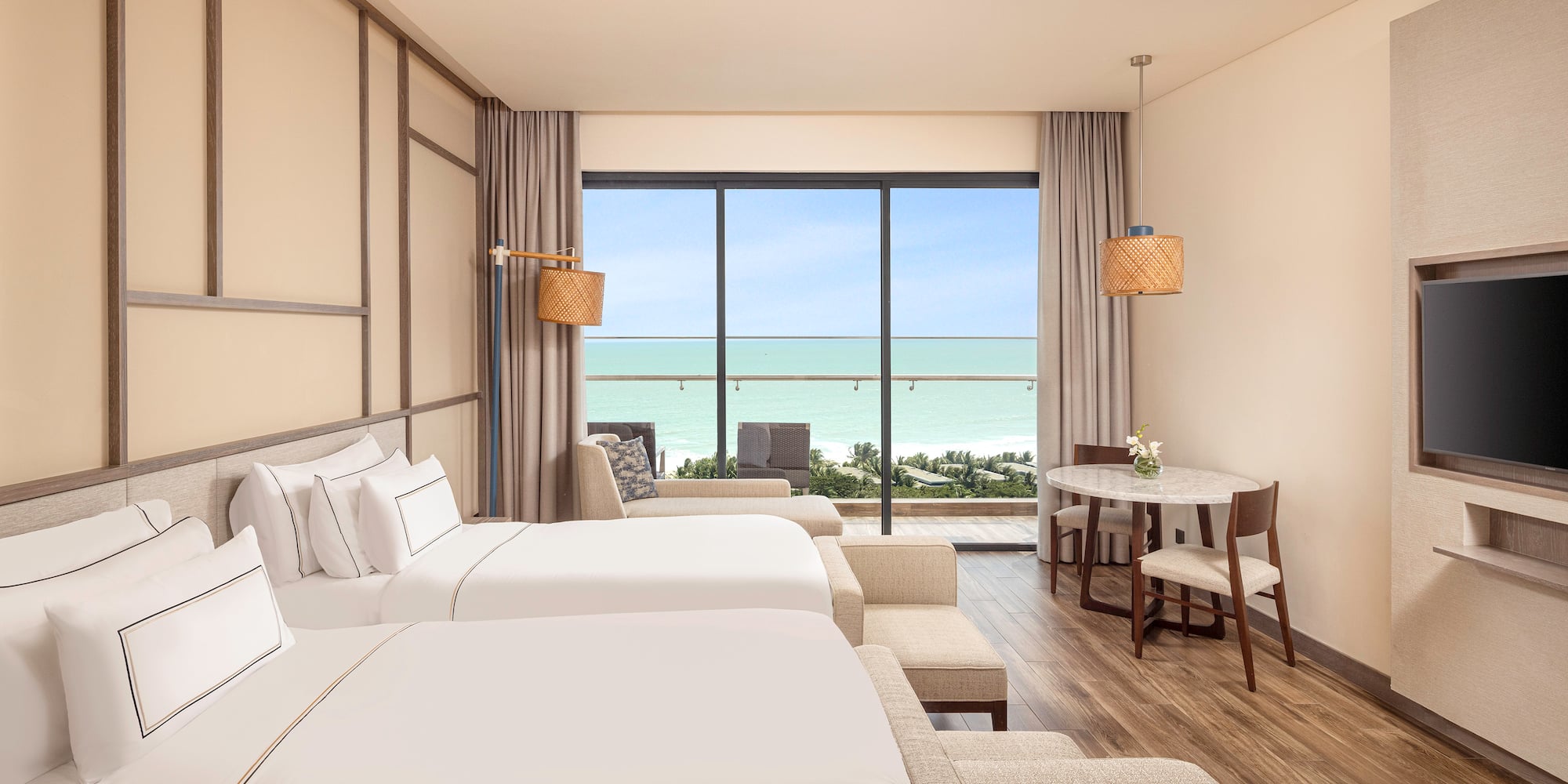 a room with two beds and a table and chairs