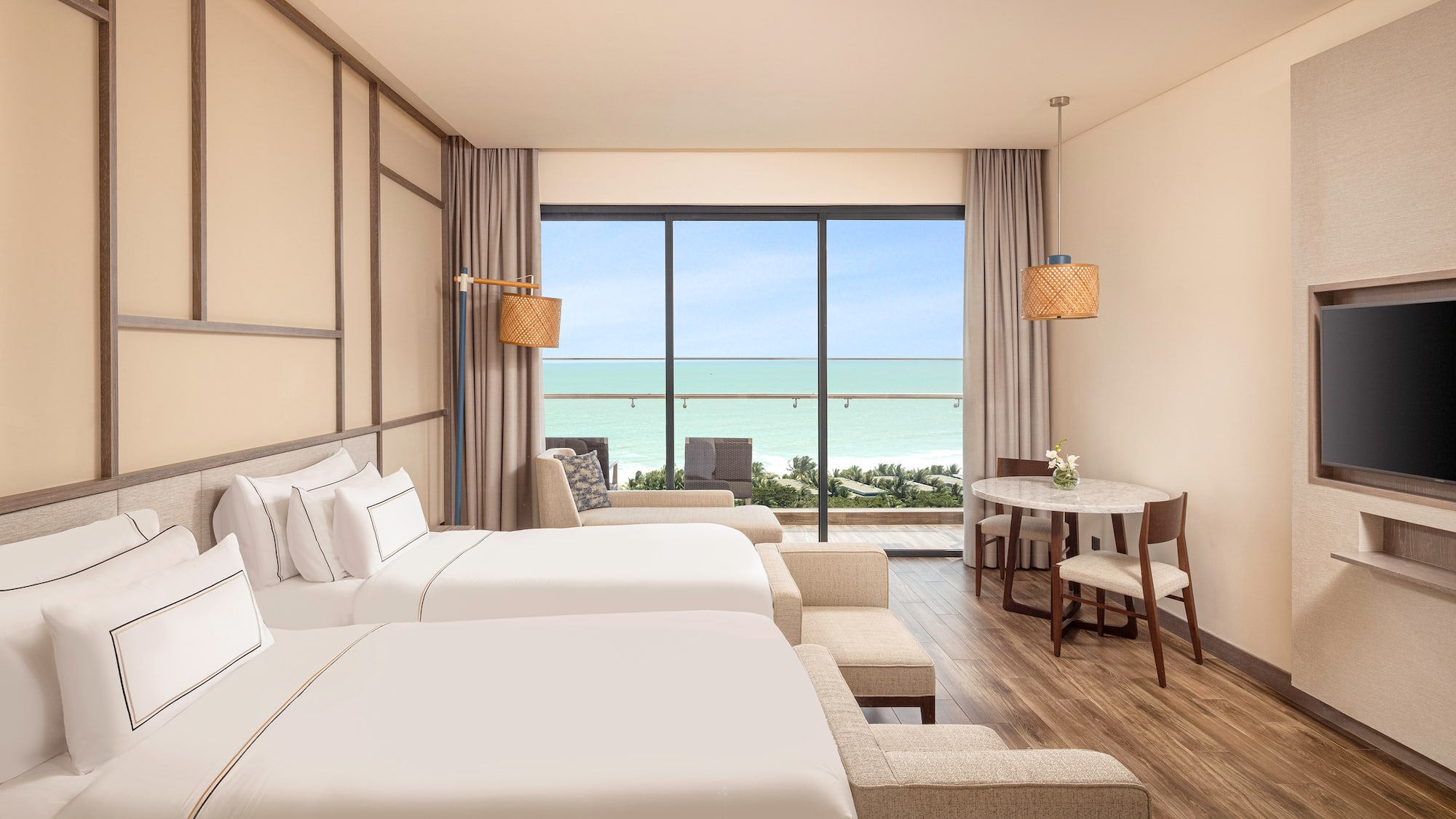 a room with two beds and a table and chairs