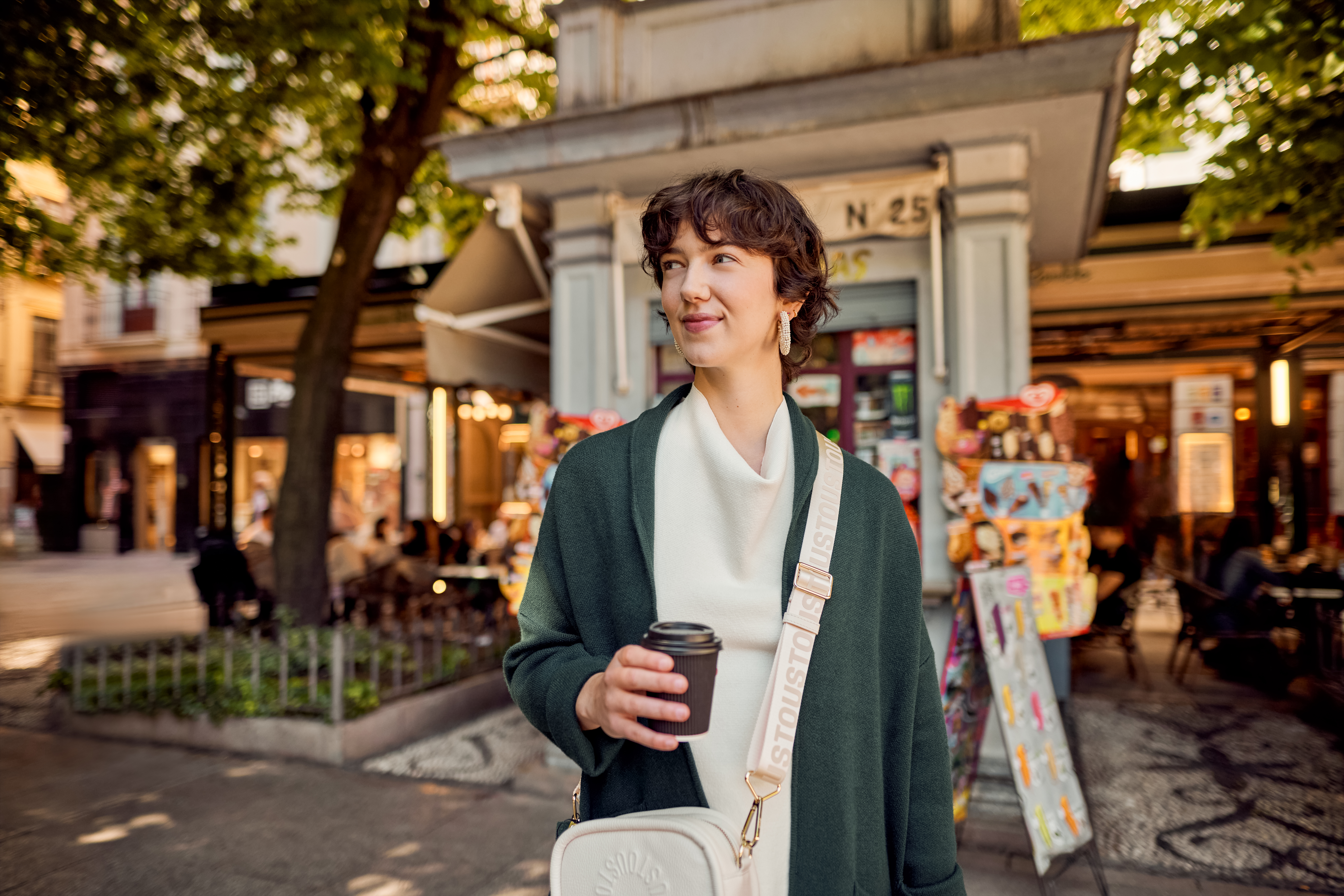 a woman holding a coffee cup