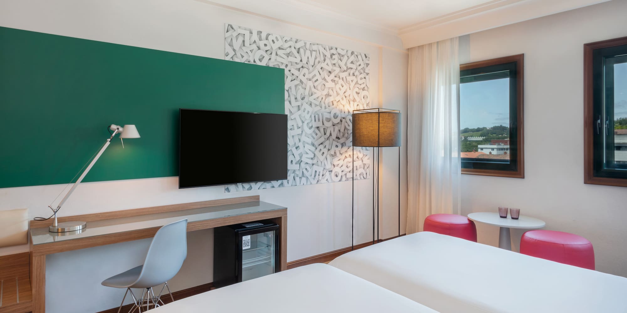 a room with two beds and a tv