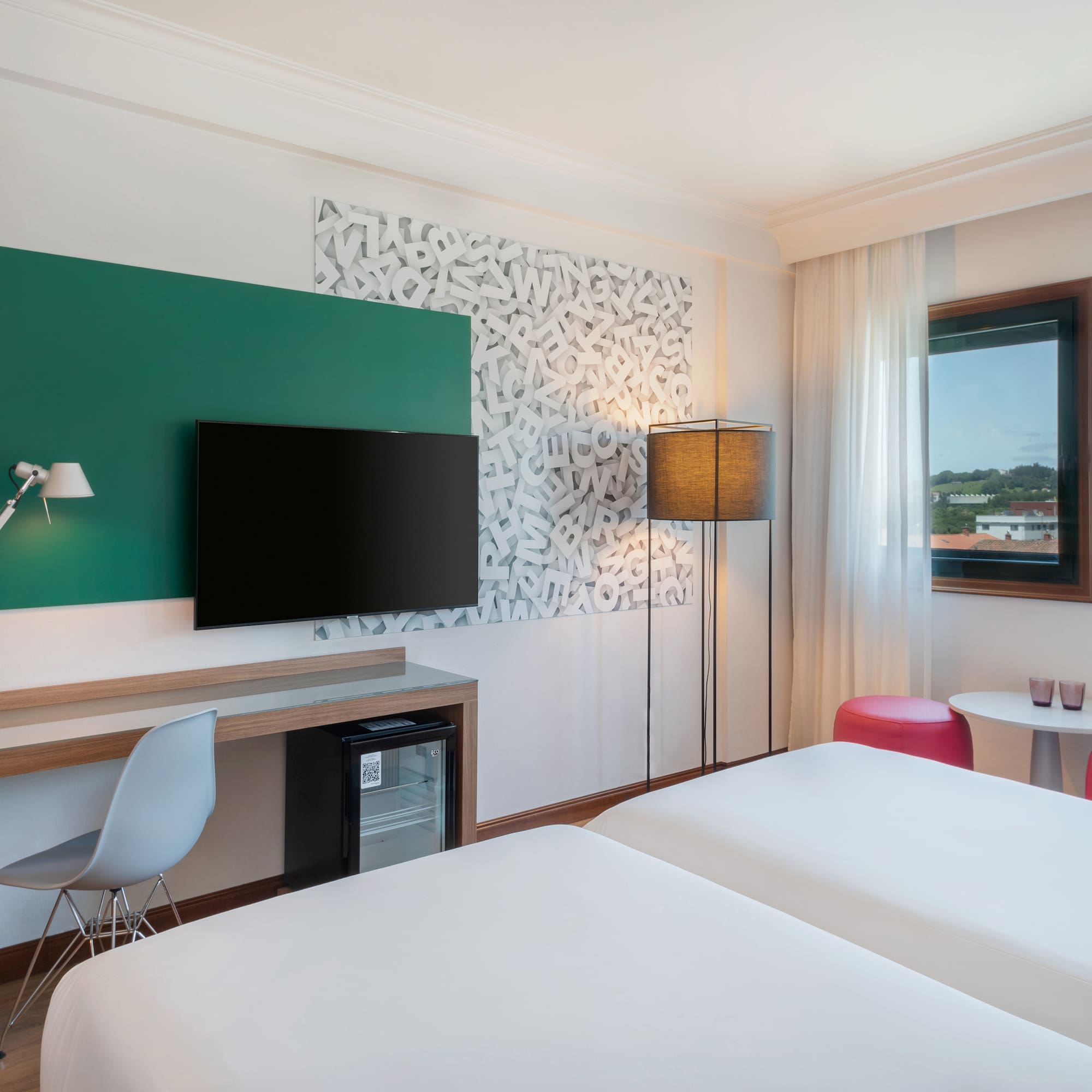 a room with two beds and a tv