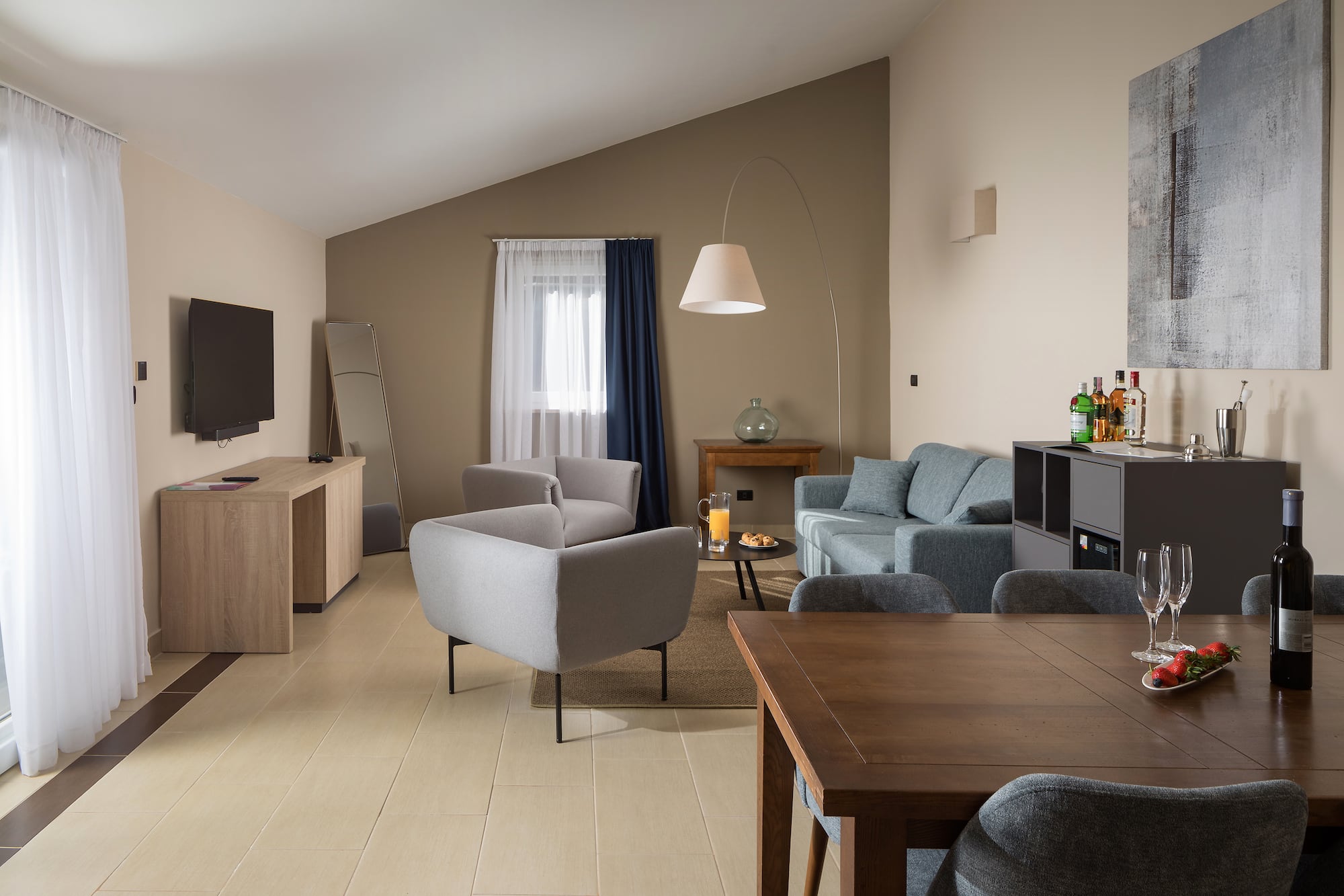 a living room with a tv and couches