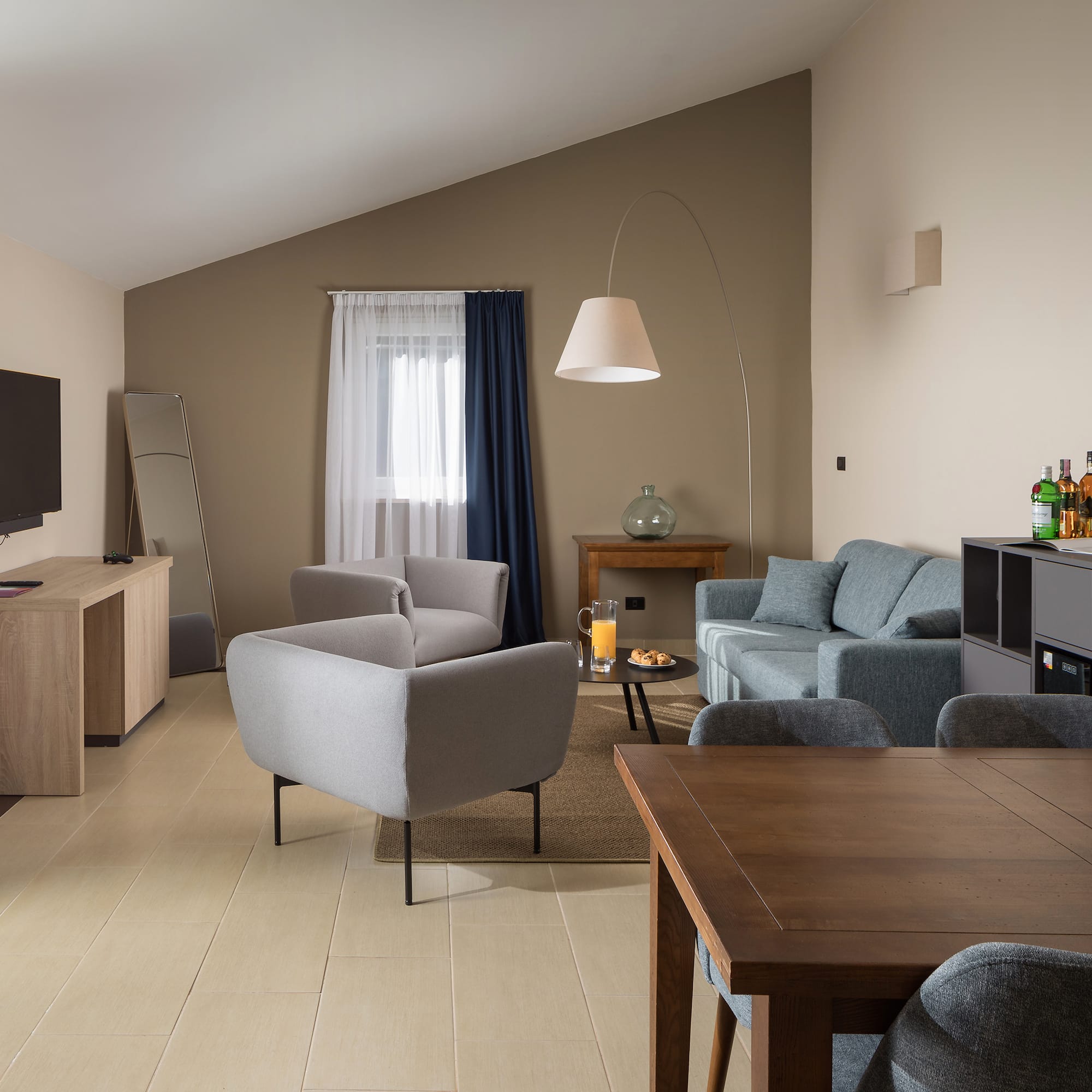 a living room with a tv and couches