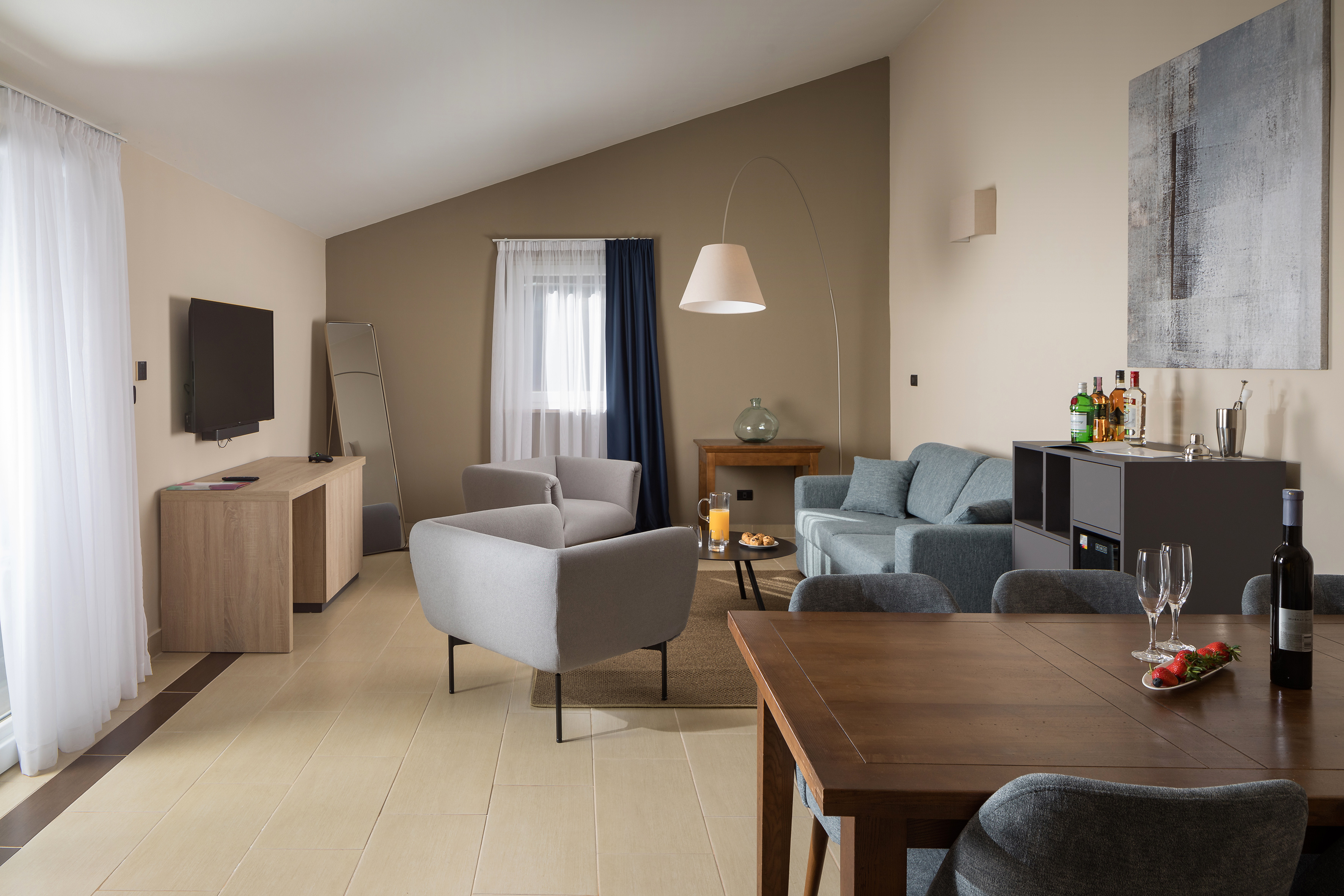 a living room with a tv and couches