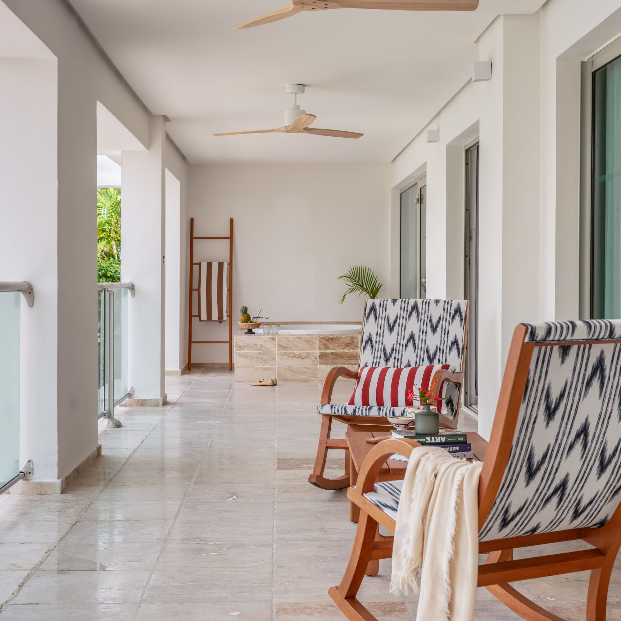 a patio with chairs and a bathtub