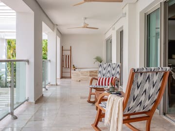 a patio with chairs and a bathtub