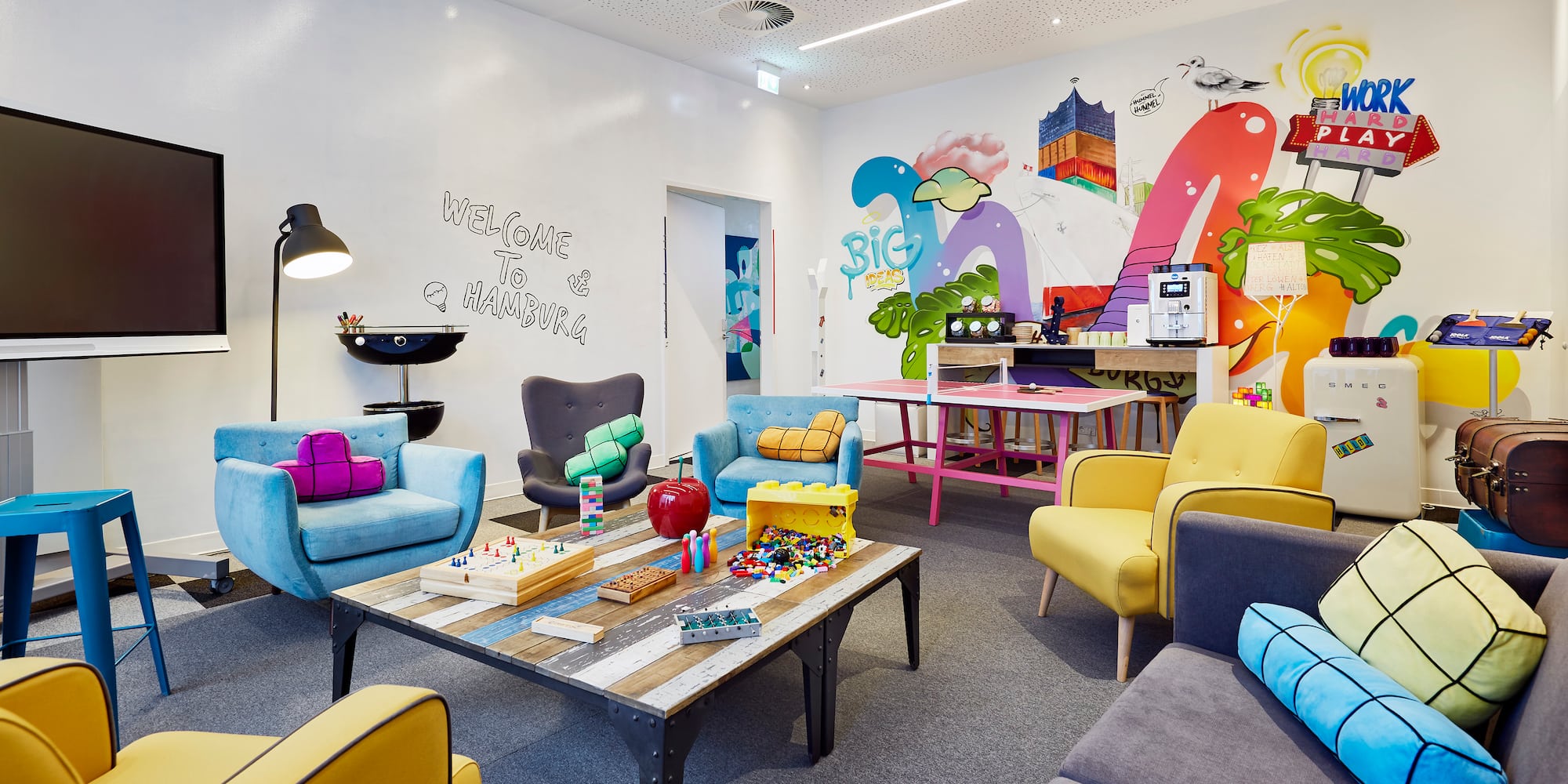 a room with colorful chairs and tables