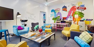 a room with colorful chairs and tables