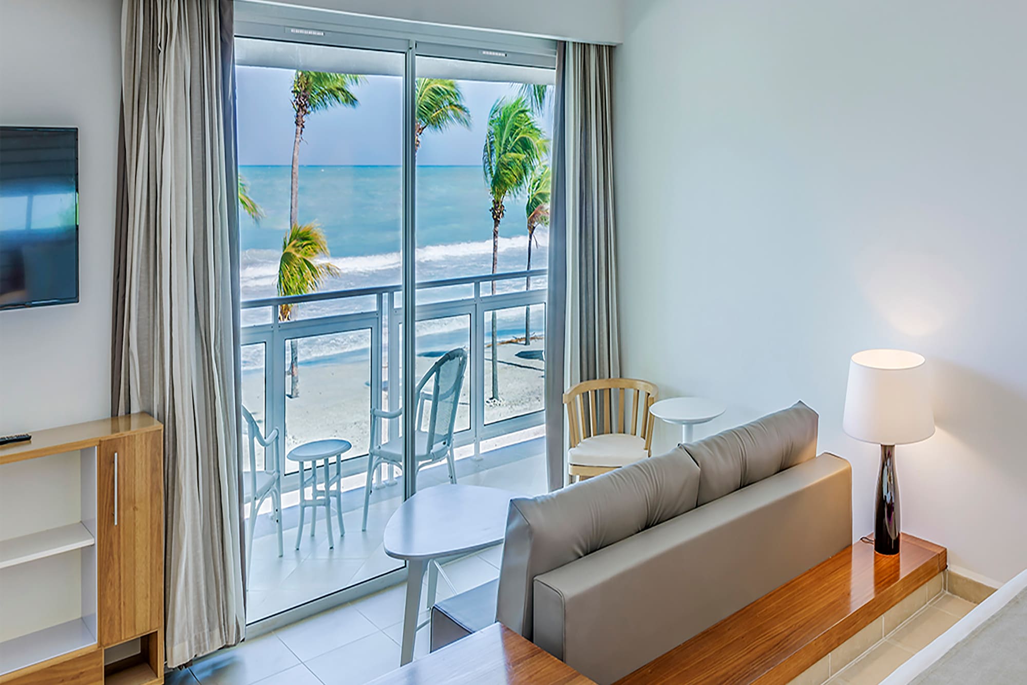 a room with a bed and a television