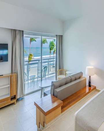 a room with a bed and a television