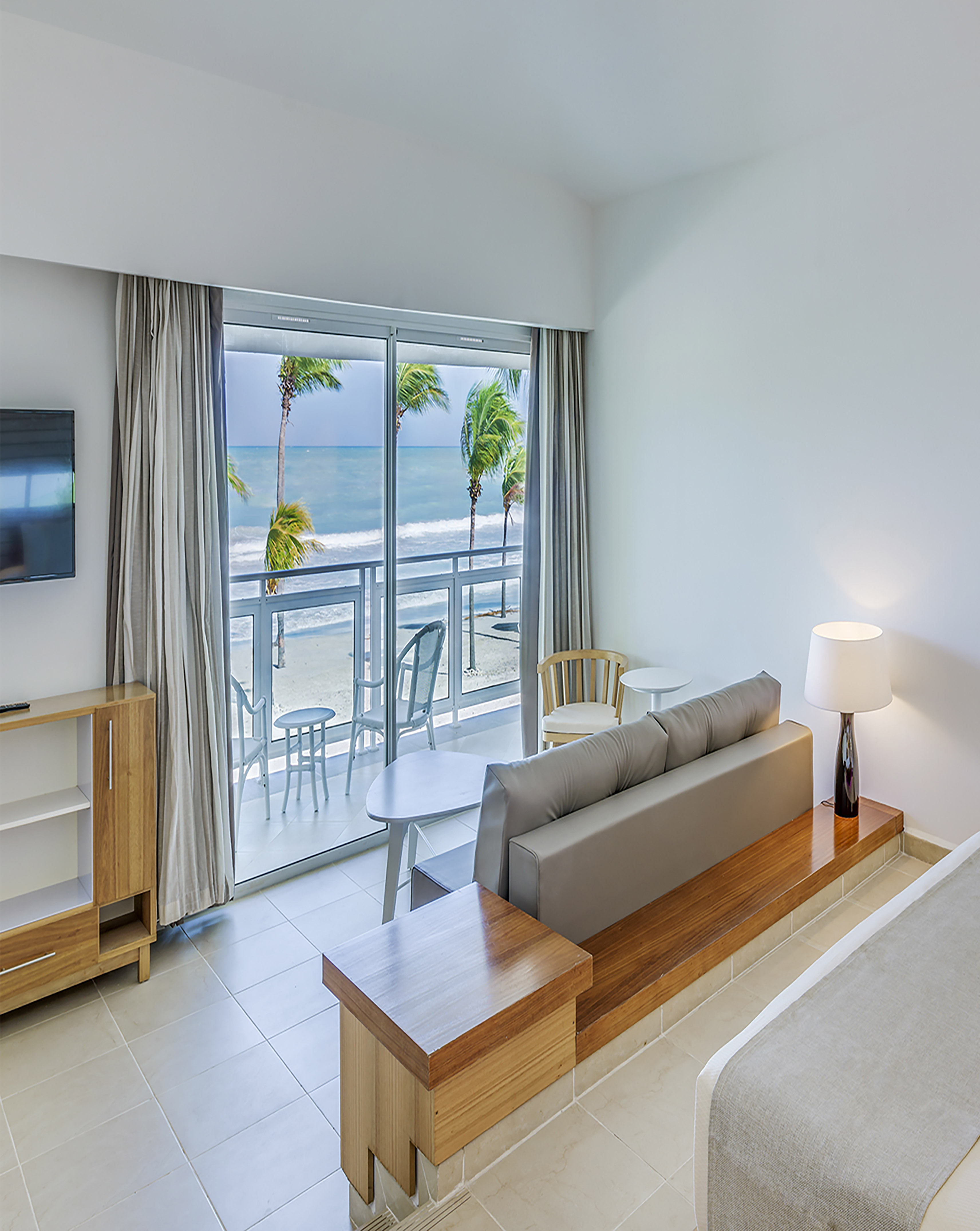 a room with a bed and a television