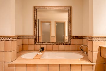 a bathroom with a large mirror and a bathtub