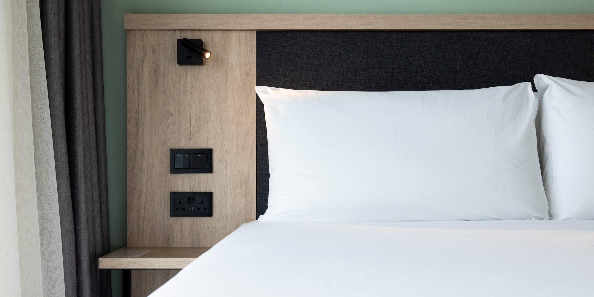 a bed with a white pillow