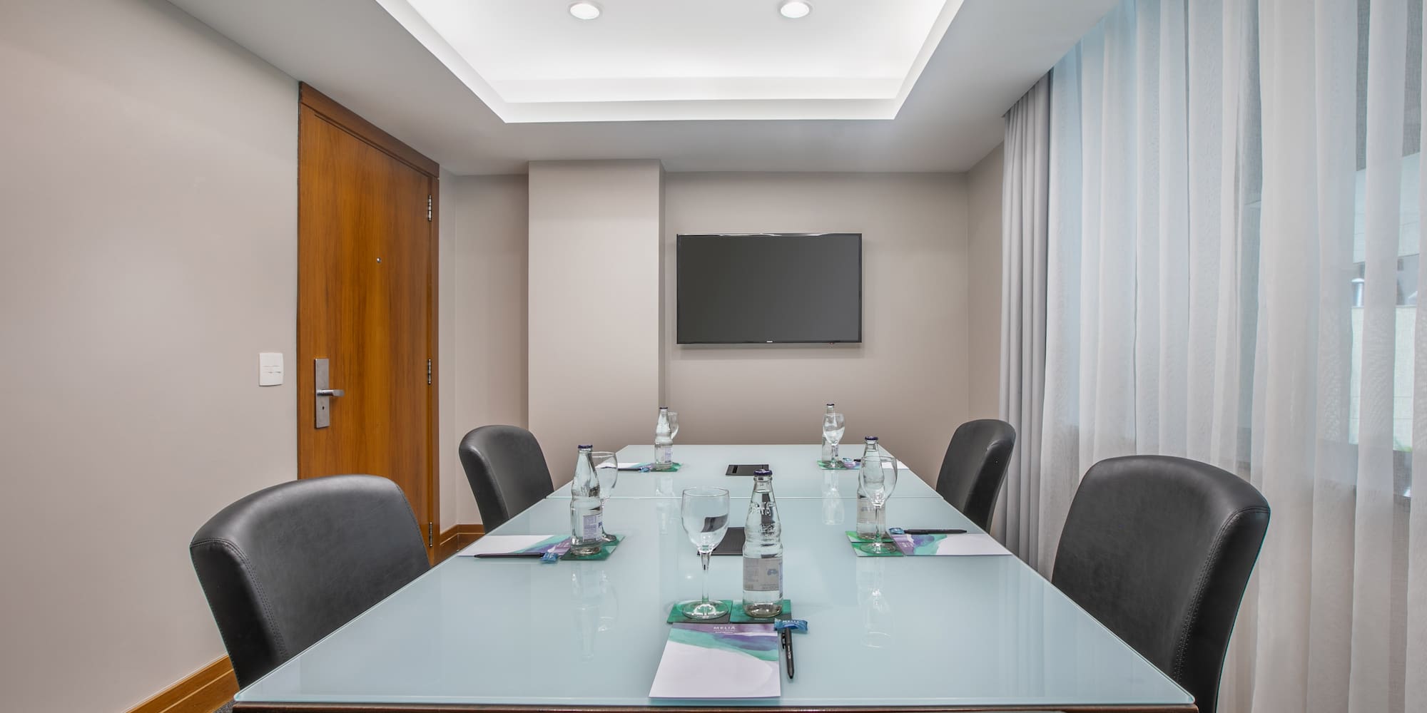 a conference room with a table and chairs