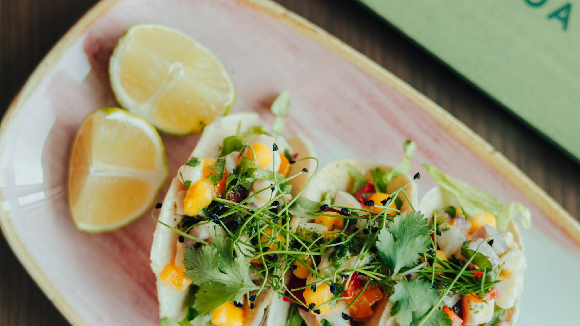 Three fresh ceviche tacos with mango, lime, and sauces at Colinas Lisboa.