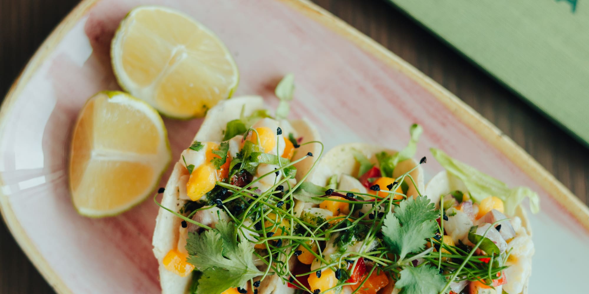 Three fresh ceviche tacos with mango, lime, and sauces at Colinas Lisboa.