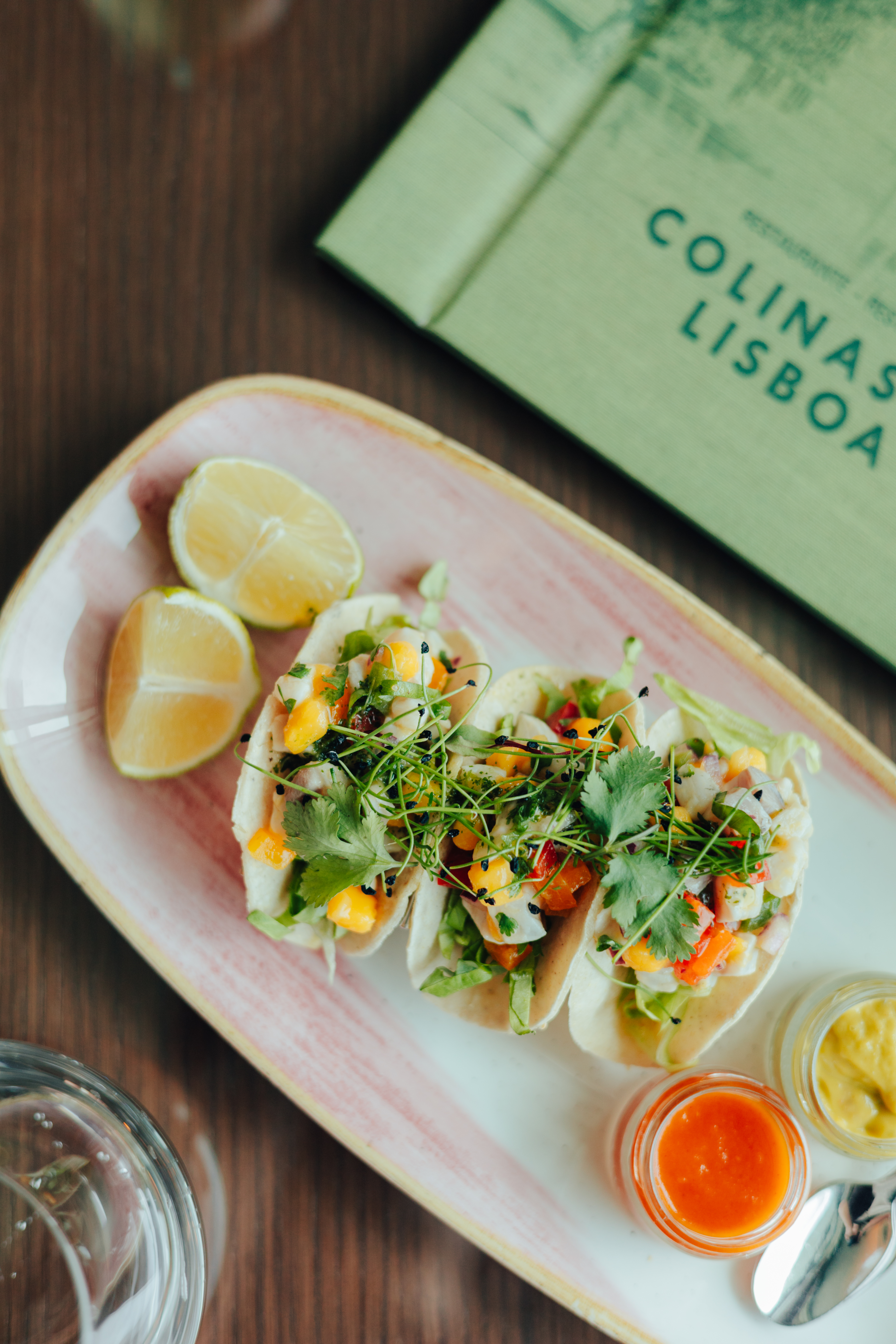 Three fresh ceviche tacos with mango, lime, and sauces at Colinas Lisboa.