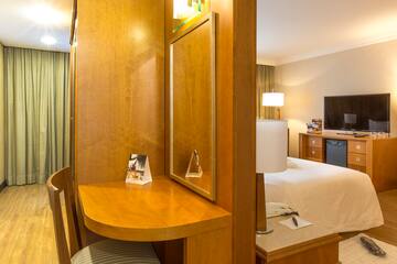 a room with a mirror and a bed