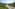 Winding road through lush green forested mountains.