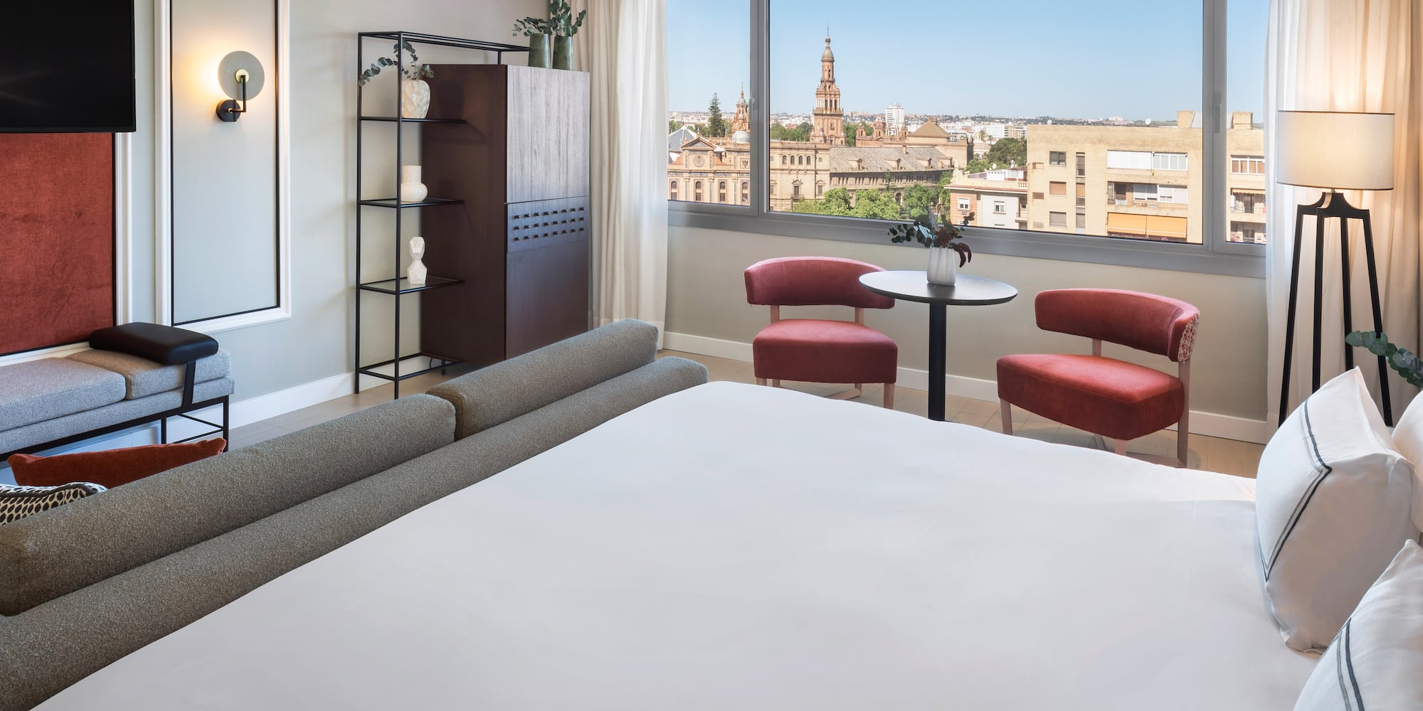 a room with a bed and chairs and a table