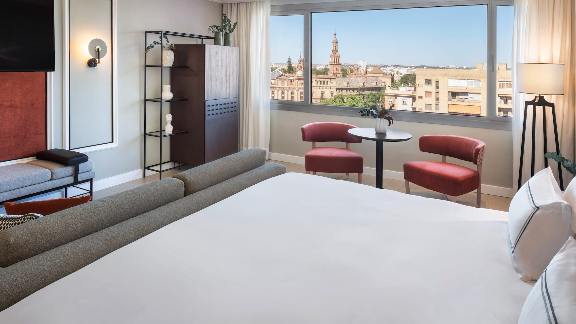 a room with a bed and chairs and a table