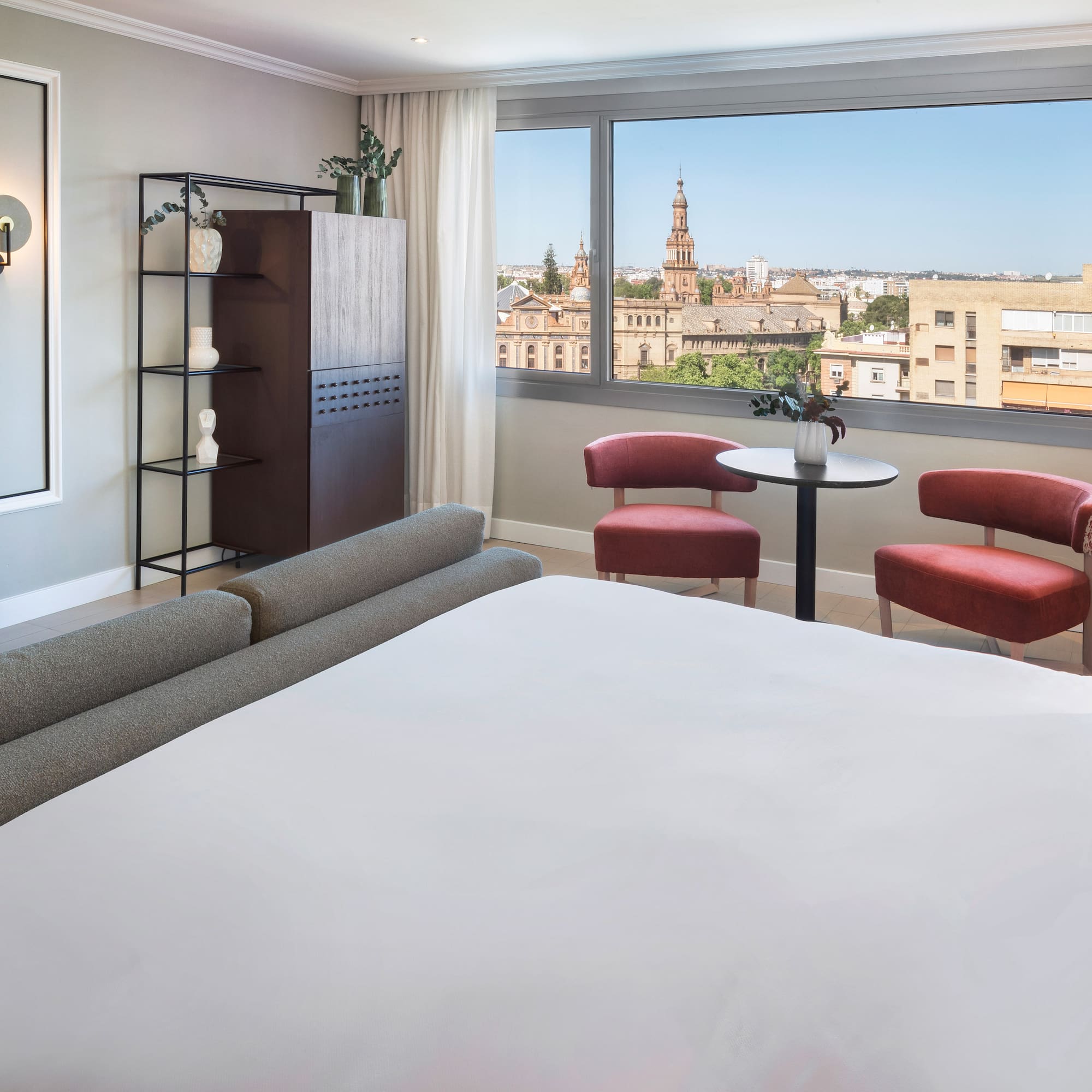 a room with a bed and chairs and a table