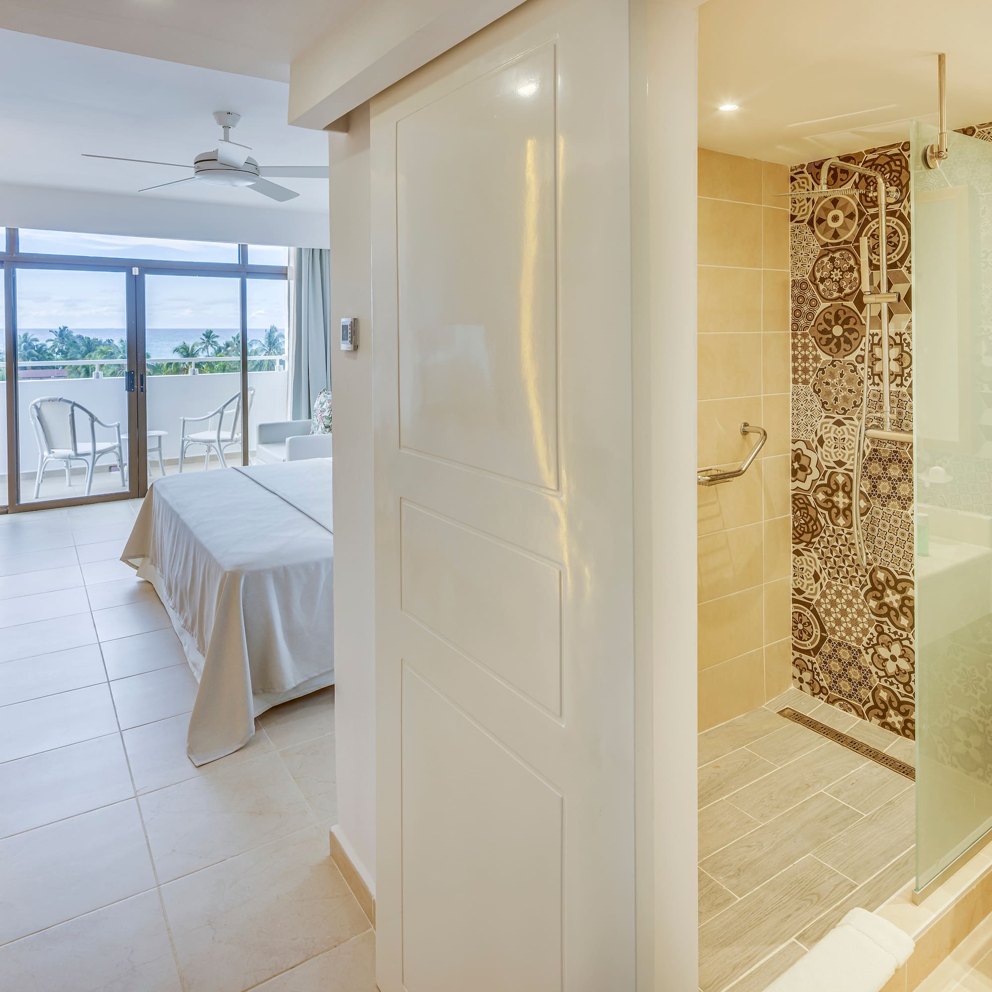 a bathroom with a bed and a glass shower