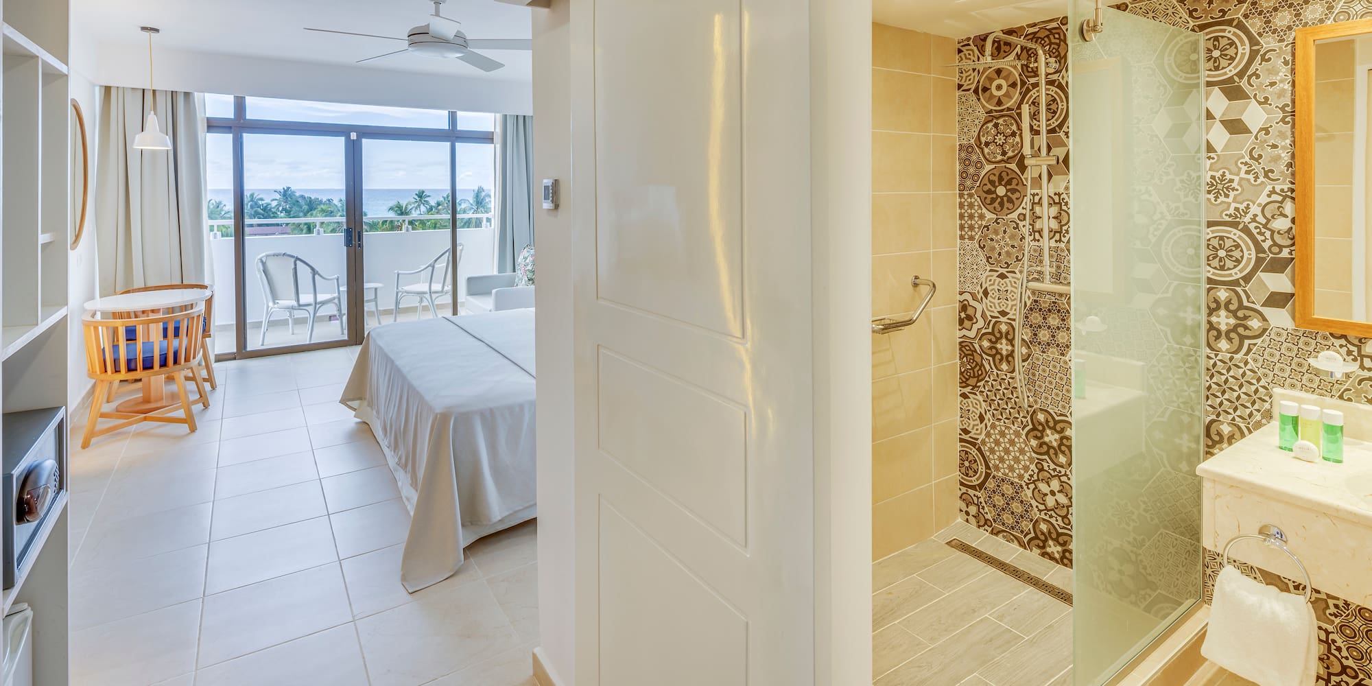 a bathroom with a bed and a glass shower