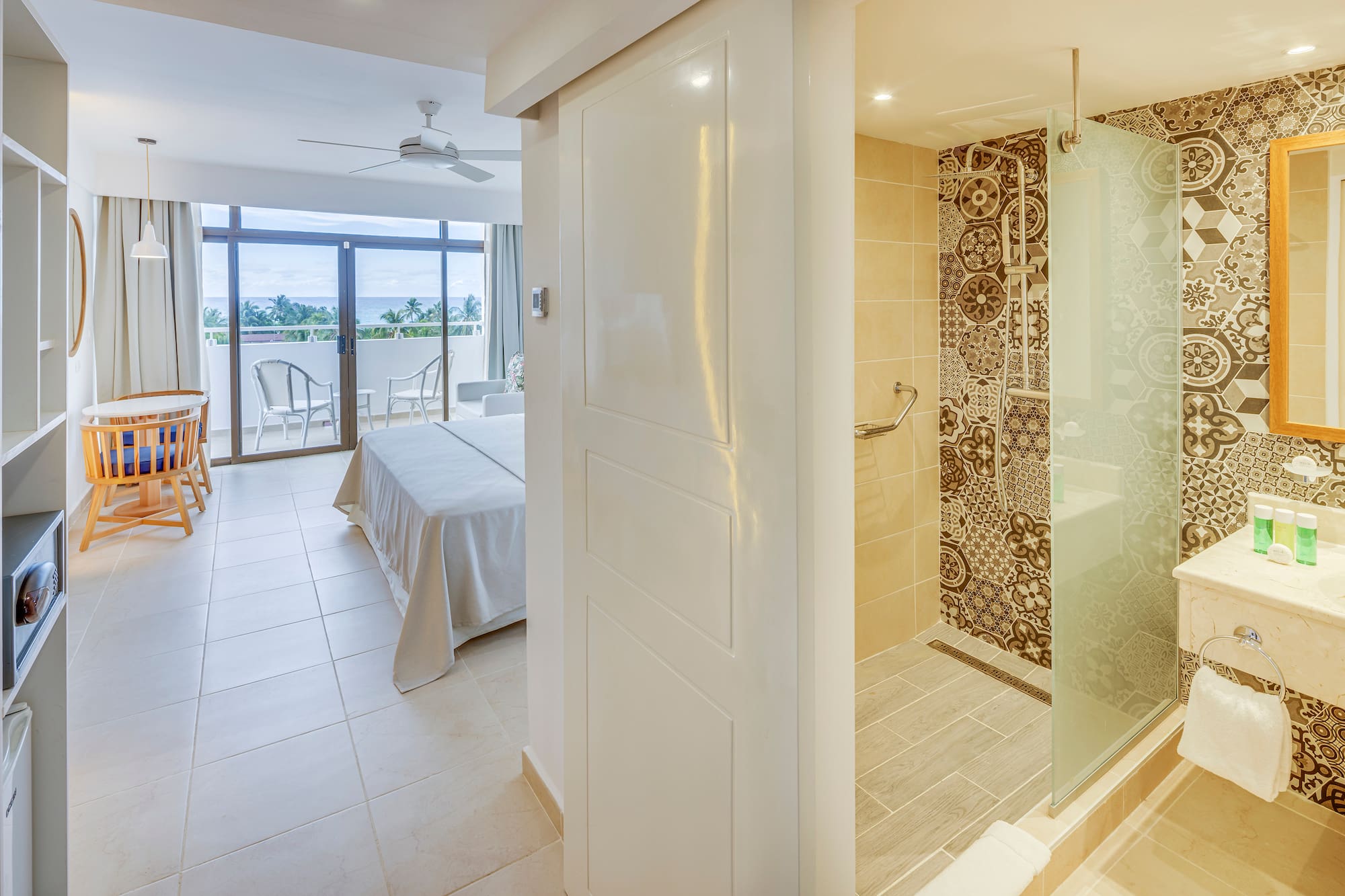 a bathroom with a bed and a glass shower