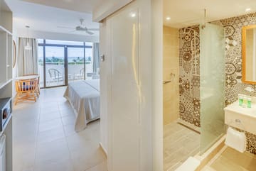 a bathroom with a bed and a glass shower