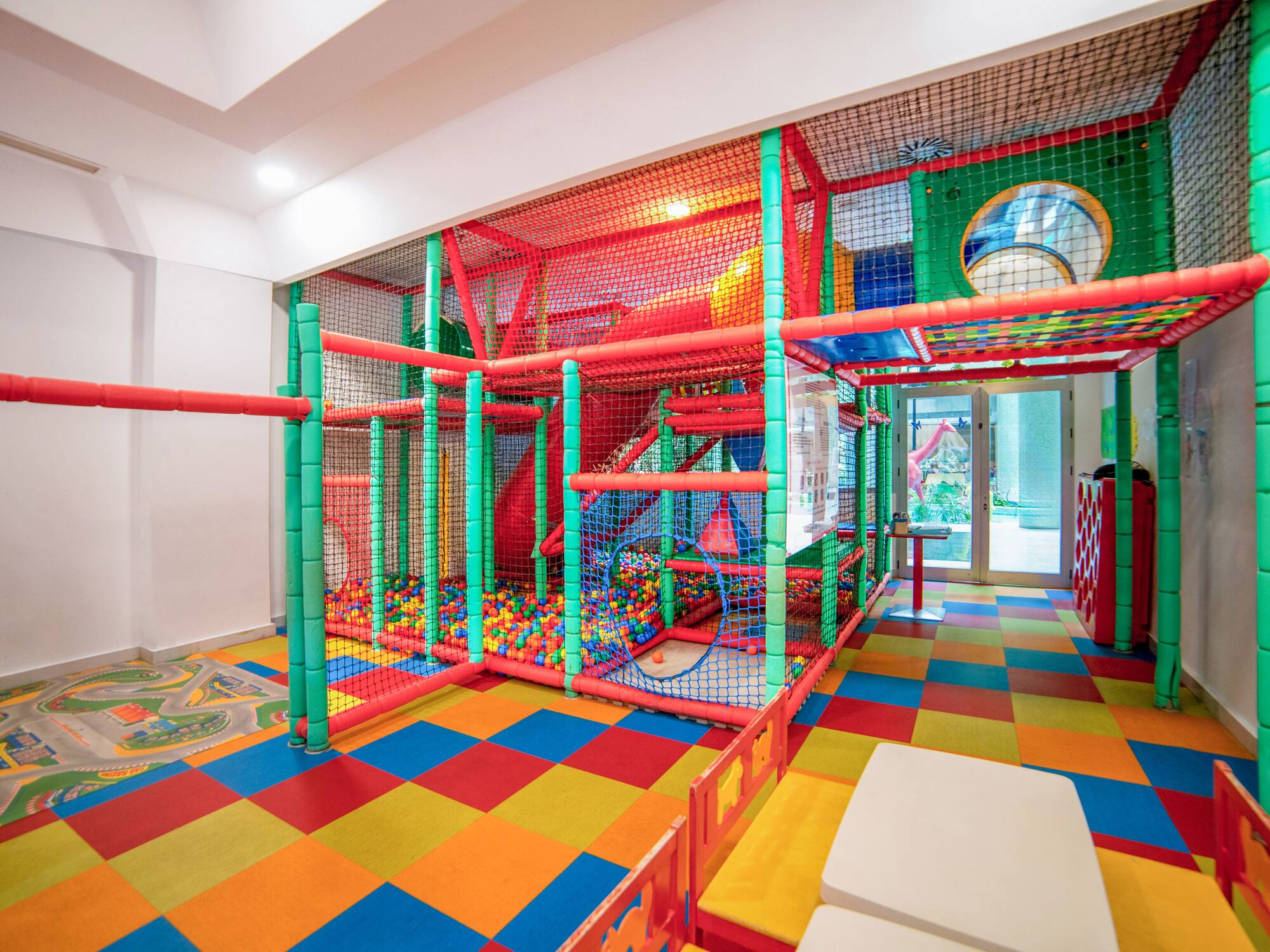 a play area with colorful balls and a slide