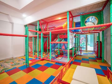 a play area with colorful balls and a slide