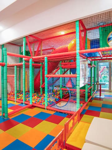 a play area with colorful balls and a slide