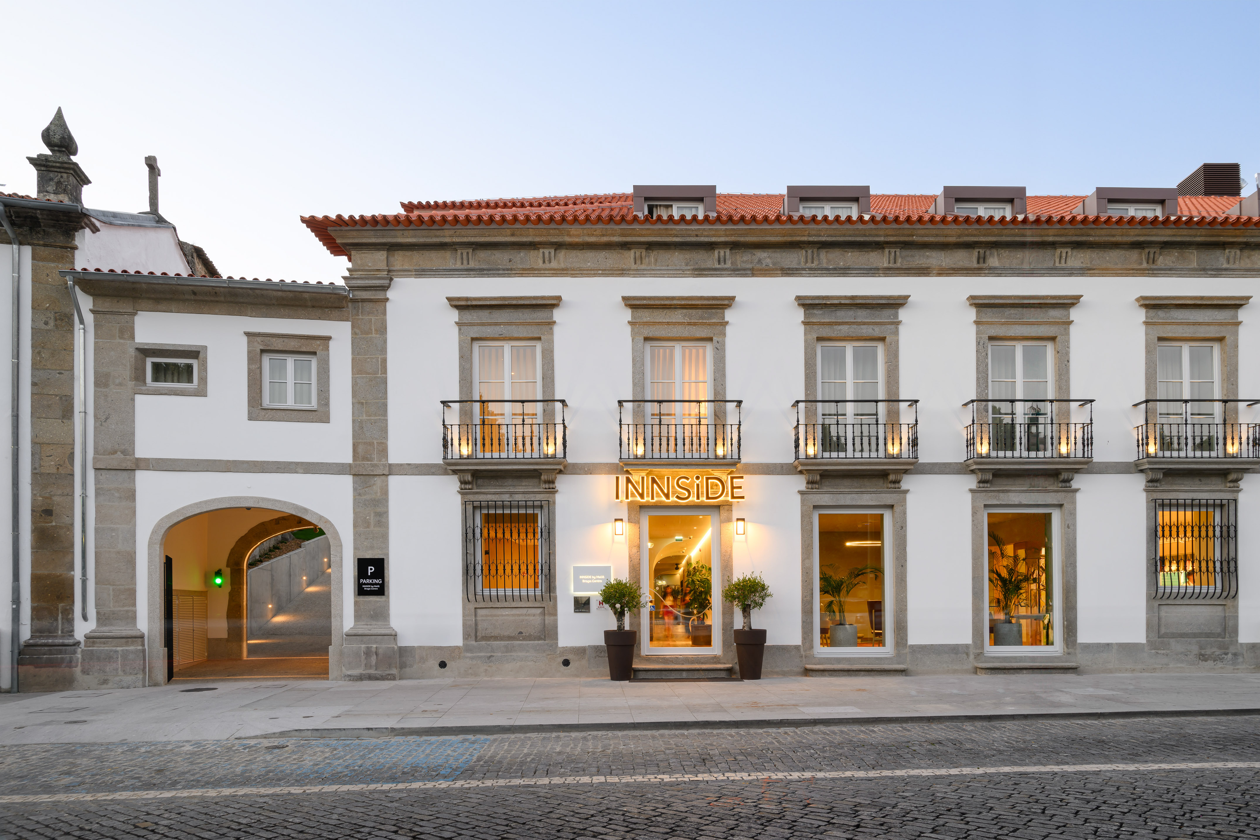 INNSIDE hotel facade with illuminated sign, traditional architecture, parking entrance. - INNSiDE Braga Centro, 브라가