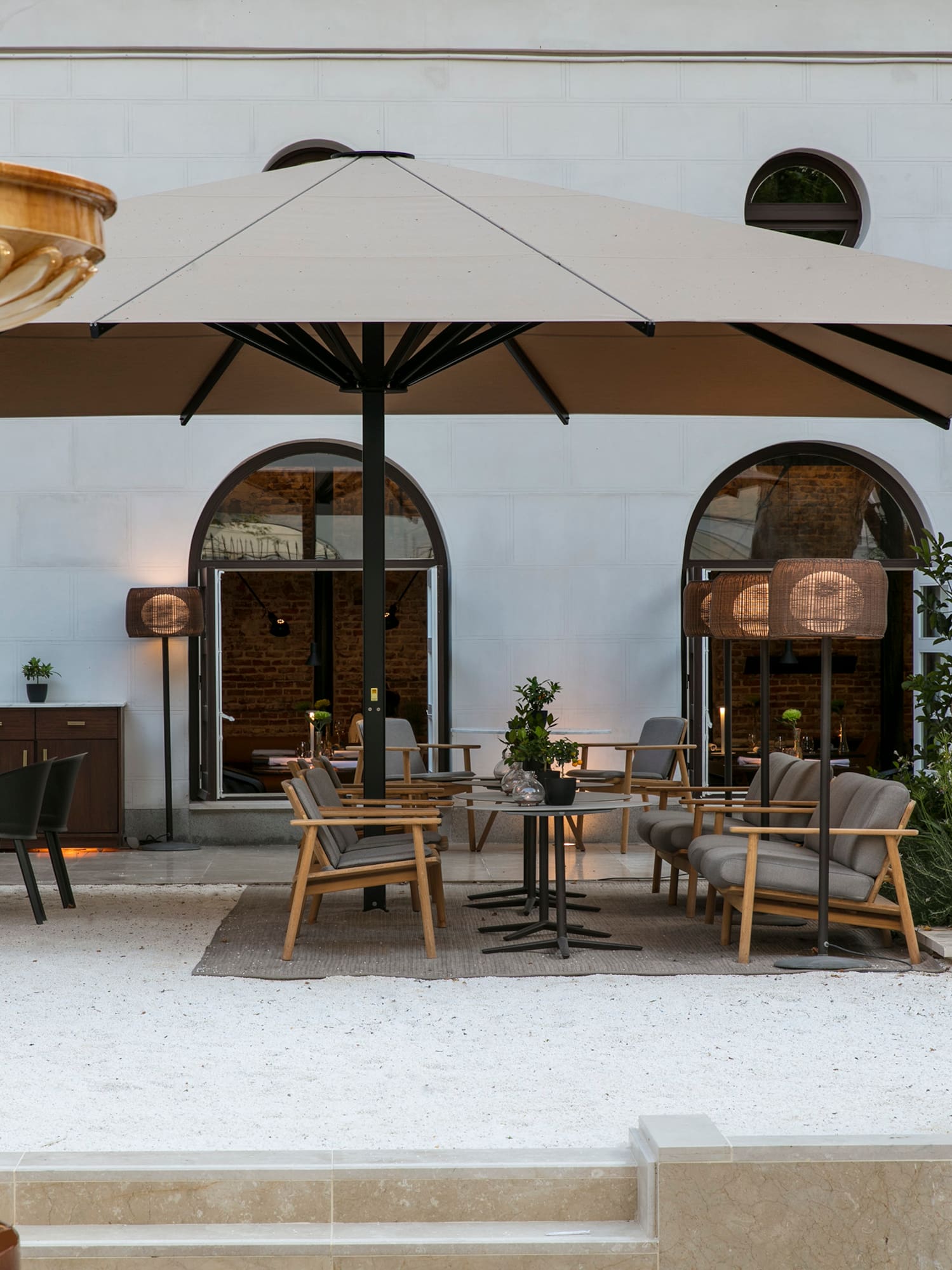 a patio area with chairs and umbrellas