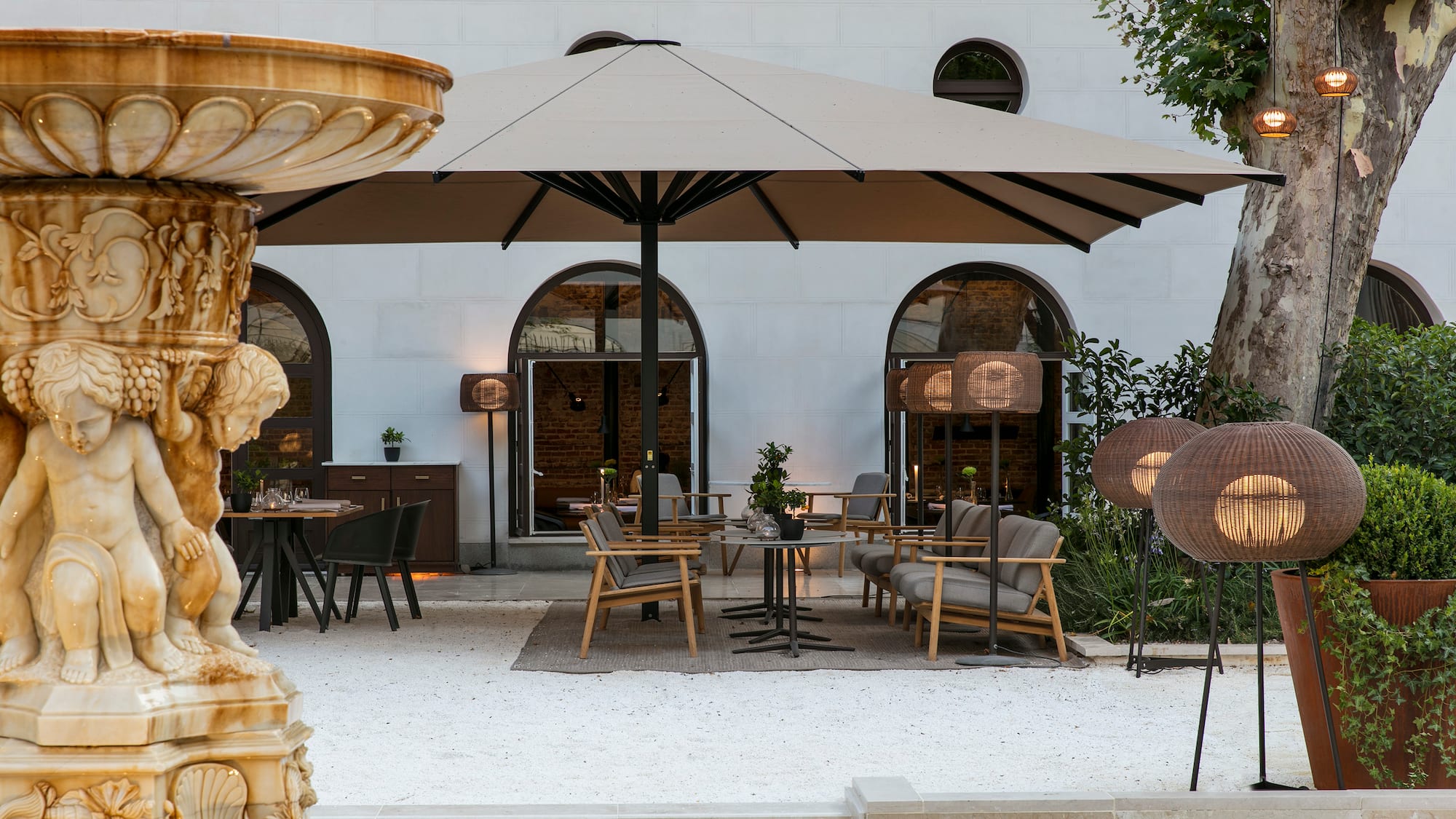a patio area with chairs and umbrellas