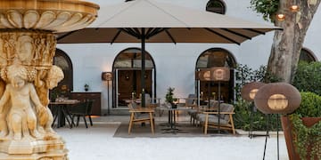 a patio area with chairs and umbrellas