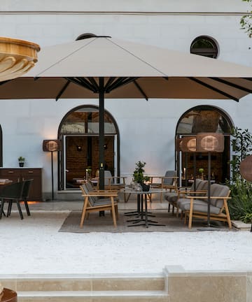 a patio area with chairs and umbrellas