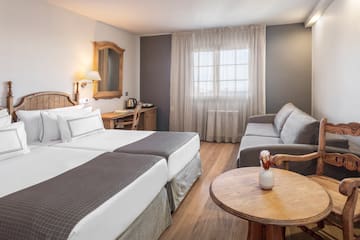 a room with two beds and a couch