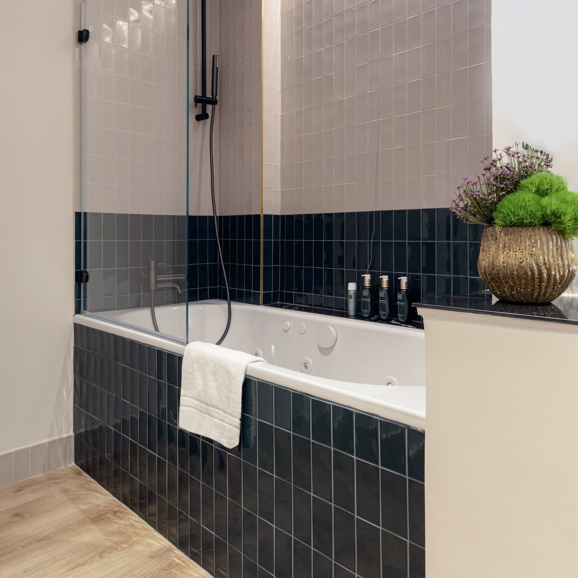 a bathroom with a bathtub and a plant